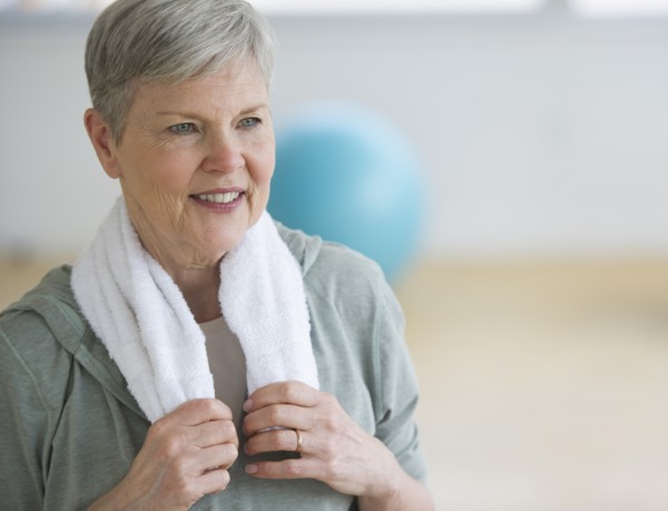 Smiling senior woman in gym.