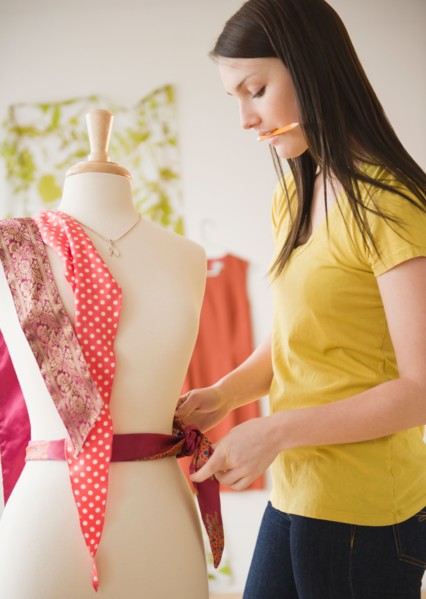 Young woman working with dressmakers model. Photo : Jamie Grill Photography