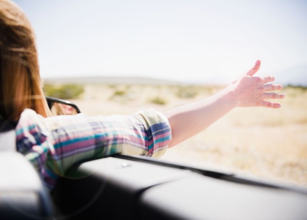 USA, California, Palm Springs, Coachella Valley, San Gorgonio Pass, Woman stretching arm outside