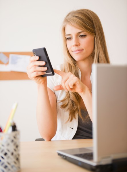 Businesswoman working at desk in office. Photo: Jamie Grill