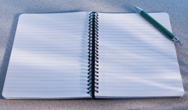 Blank open notebook and pencil. Photo: Daniel Grill