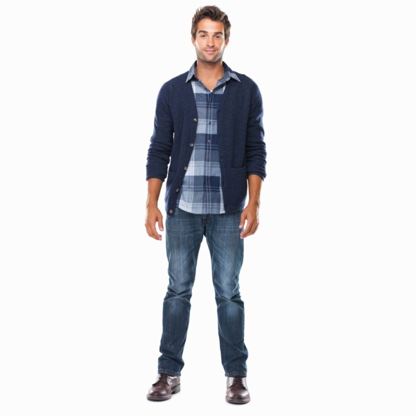 Studio shot of young confident man standing on white background and smiling. Photo: momentimages