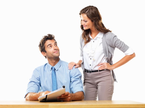 Business woman and business man reading document together. Photo: momentimages