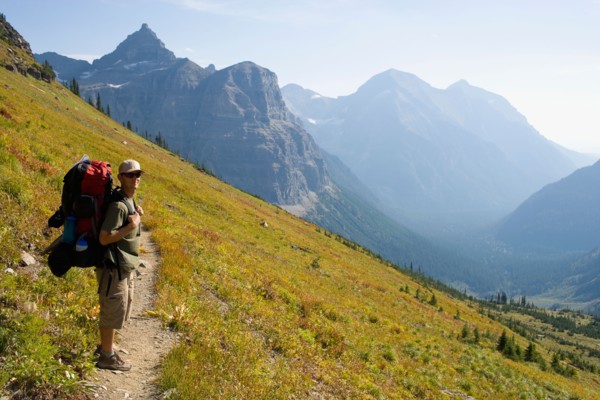 USA, Montana, Glacier National Park, Browns Pass, Mid adult hiker posing . Photo: Noah Clayton