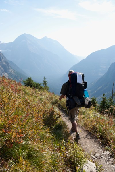 USA, Montana, Glacier National Park, Browns Pass, Mid adult hiker walking. Photo: Noah Clayton