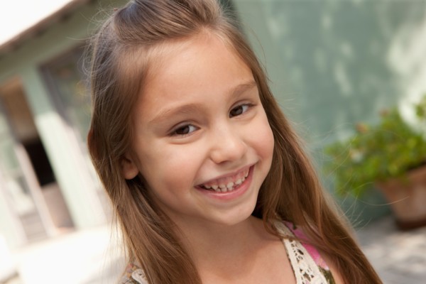 Portrait of cheerful girl (6-7). Photo : Rob Lewine