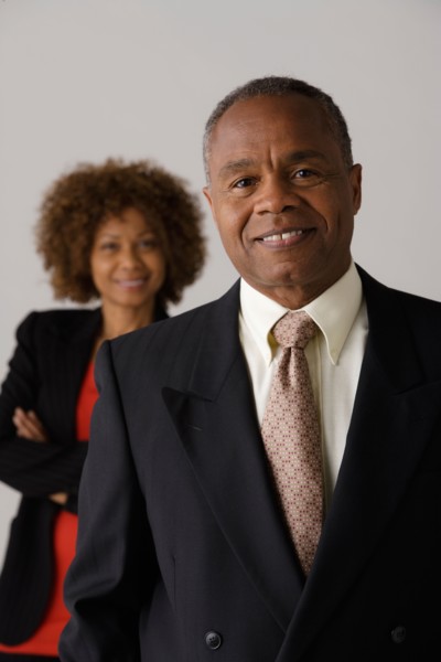 Mature business people, studio shot. Photo : Rob Lewine