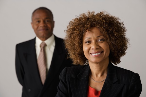 Mature business people, studio shot. Photo: Rob Lewine