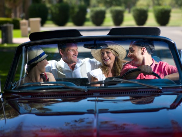 Friends driving convertible car. Photo: db2stock