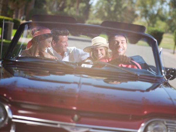 Friends driving convertible car. Photo: db2stock