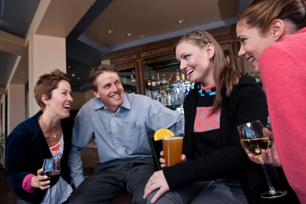 Group of people enjoying apres ski drink in bar. Photo: db2stock