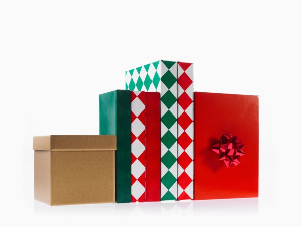 Four boxes with ribbon, studio shot. Photo : David Arky