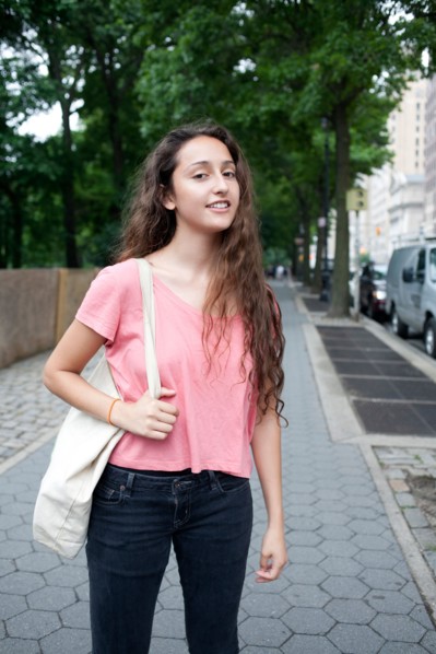 USA, New York, New York City, Portrait of smiling young woman standing on street. Photo : Winslow