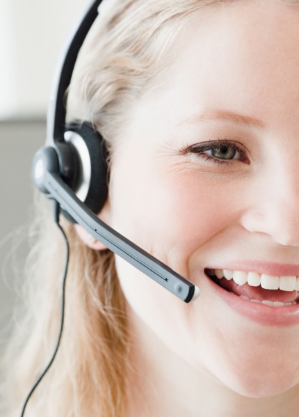 Young woman wearing headset. Photo : Jamie Grill