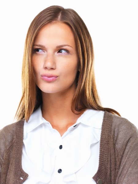 Studio portrait of beautiful business woman looking away with lips pursed. Photo : momentimages