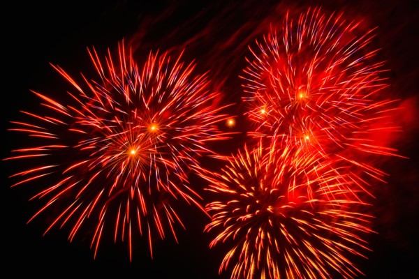 Fireworks explosion against night sky.