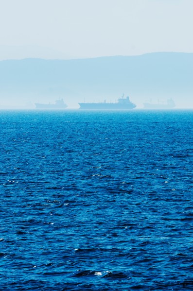 Greece, Oil tankers and cargo ships on Aegean Sea.
