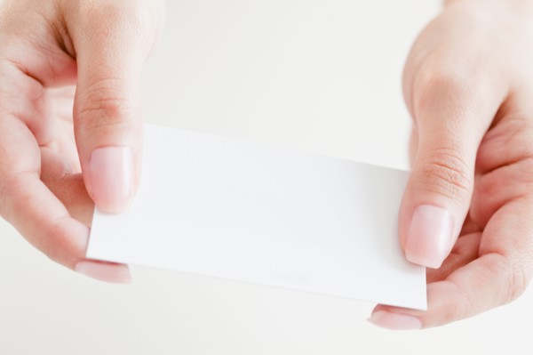 Close up of woman's hands holding credit card. Photo : Jamie Grill