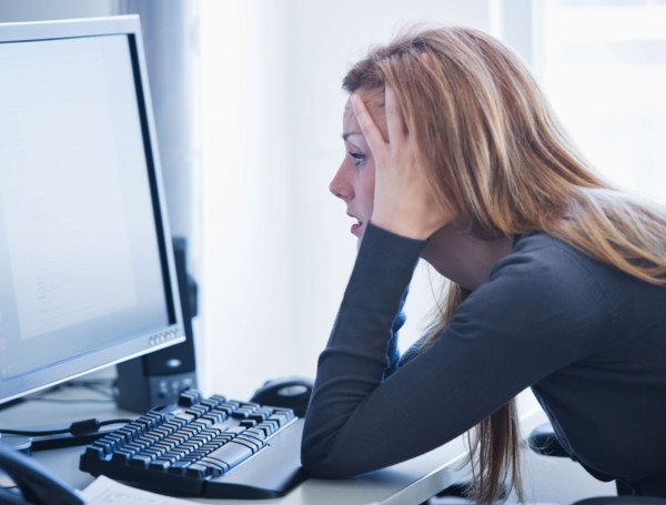 Young woman working in office. Photo: Daniel Grill