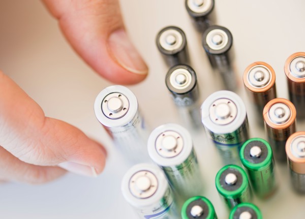 Hand holding batteries.