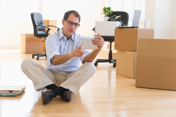Businessman using palmtop in new office.