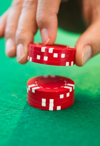Hand handling gambling chips.