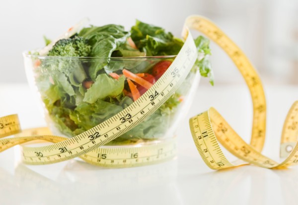Bowl of salad and tape measure. Photo: Jamie Grill