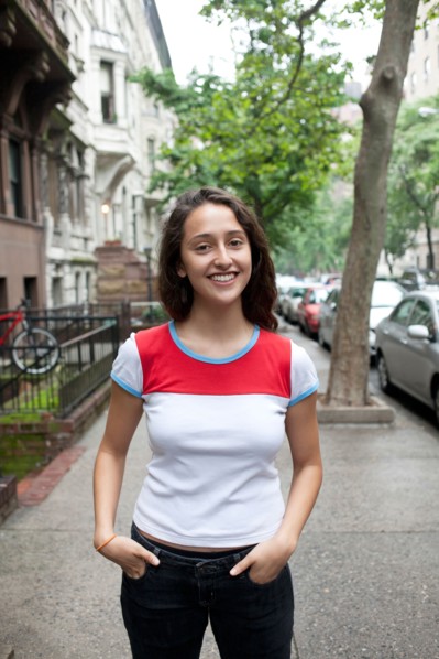 USA, New York, New York City, Portrait of smiling young woman standing on street. Photo : Winslow