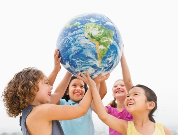 Girls (6-9) holding globe.