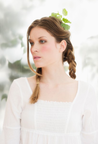 Young woman with leaves in hair.