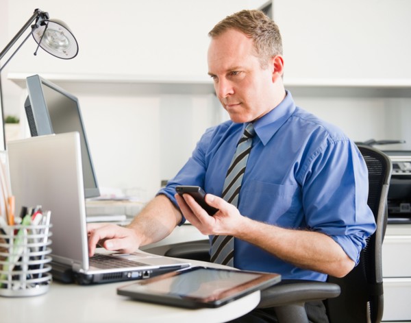Businessman working in office. Photo: Jamie Grill