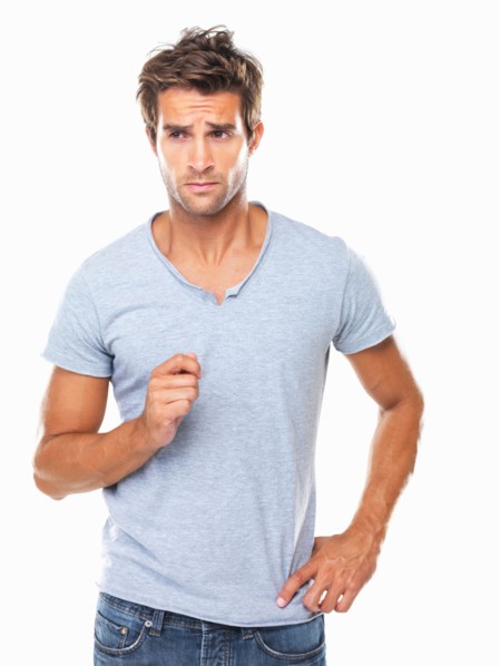 Studio shot of young man with furrowed forehead looking away. Photo : momentimages