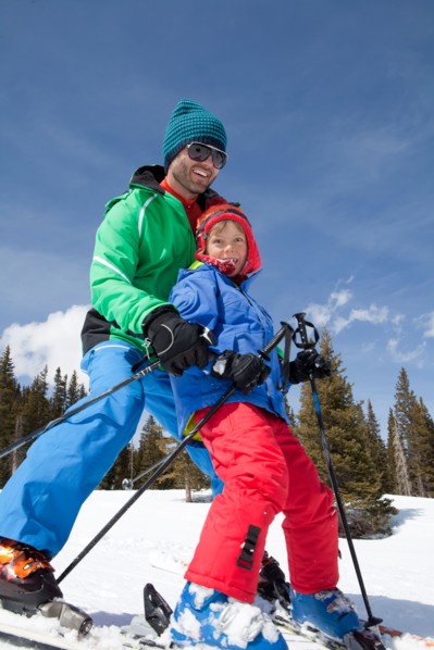 USA, Colorado, Telluride, Father with son (8-9) skiing together. Photo : db2stock