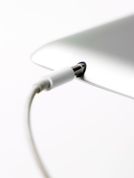 Studio shot of mobile phone with charger. Photo : David Arky