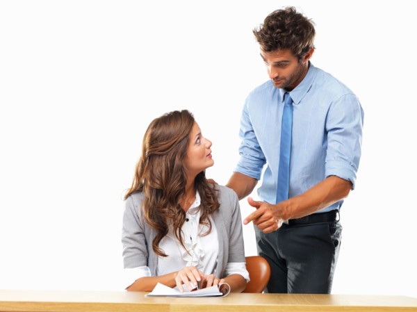 Business woman and business man reading document together. Photo : momentimages