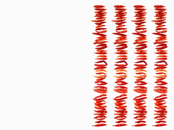 Studio shot of Red Chili Peppers on white background. Photo : David Arky