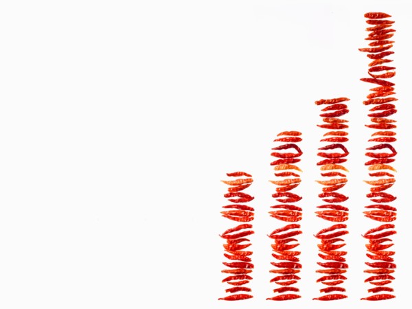 Studio shot of Red Chili Peppers on white background. Photo : David Arky