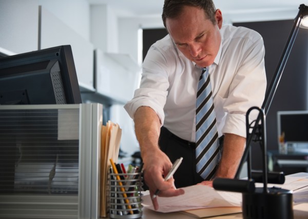 Businessman working in office. Photo : Jamie Grill