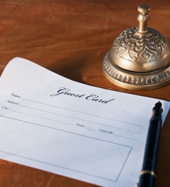 Close up of antique guest card and service bell. Photo : Daniel Grill