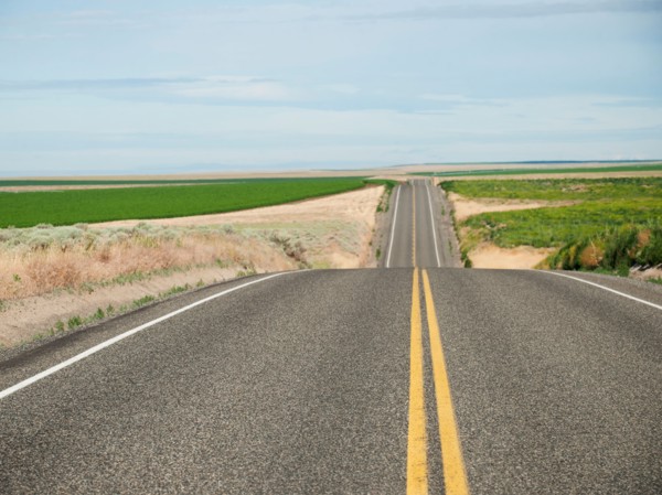 USA, Oregon, Boardman, Rolling landscape with empty road.