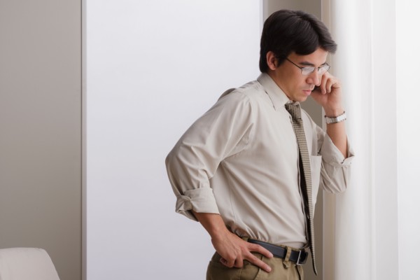 Young businessman using cell phone. Photo : Rob Lewine