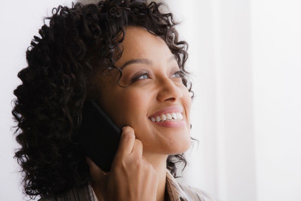 Portrait of smiling businesswoman on phone. Photo : Rob Lewine