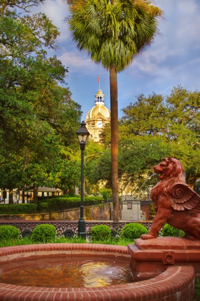 USA, Georgia, Savannah, Fountain in park with dome of City Hall in background.