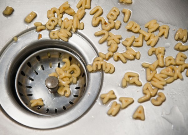 Close up of letter noodles in kitchen sink. Photo : Jamie Grill