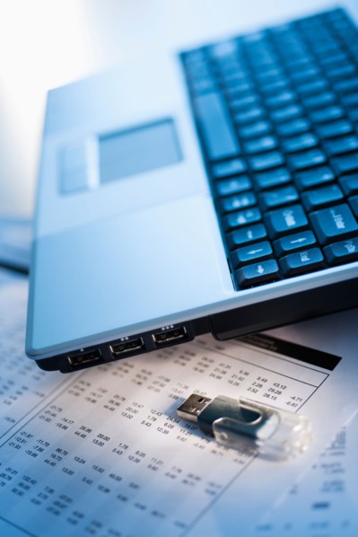 Studio shot of laptop with memory stick.