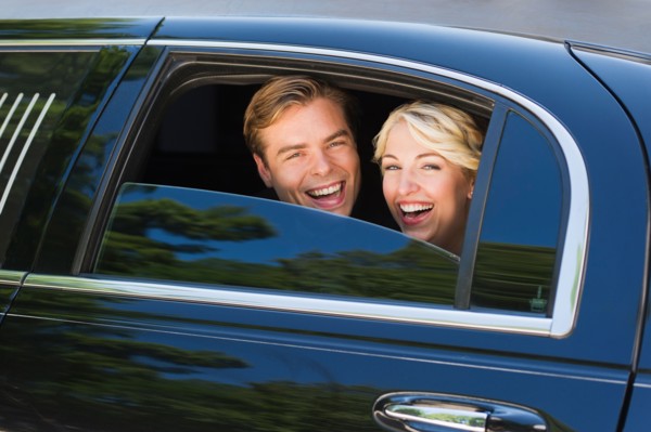 Happy married couple in limousine.