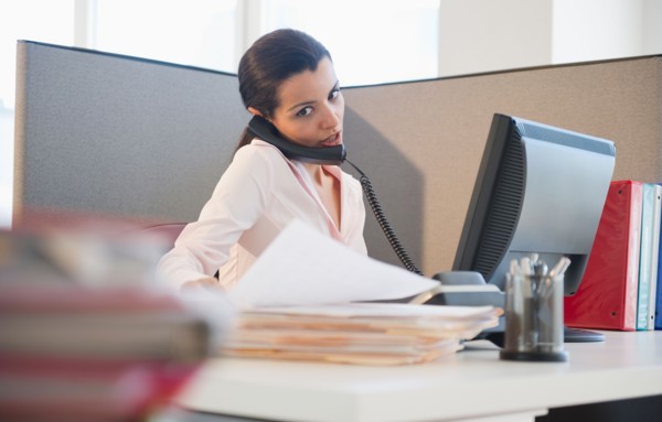 Businesswoman working at desk in office. Photo : Jamie Grill