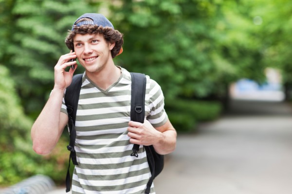 Male college student talking on cell phone. Photo: Take A Pix Media