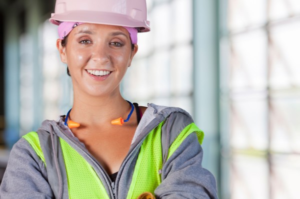 Portrait of female manual worker wearing hardhat. Photo : db2stock