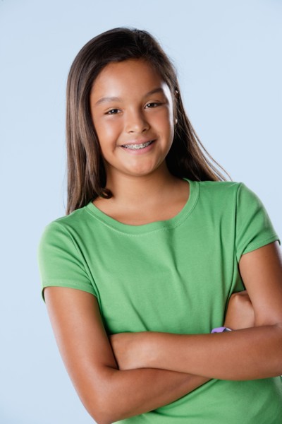 Studio portrait of girl smiling (10-11). Photo : Rob Lewine